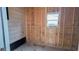 Exposed framing on inside of empty shed with window and partial exterior siding at 509 Tivoli Park Dr, Davenport, FL 33897