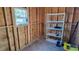 Inside of shed featuring exposed framing, shelving unit, and window with natural light at 509 Tivoli Park Dr, Davenport, FL 33897