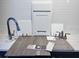 Bathroom design elements showcasing white cabinets, subway tile, chrome faucet, and wood-look flooring at 1007 Wisteria Way, Dundee, FL 33838