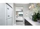 Modern bathroom featuring a tiled shower, double vanity sinks, and a view into an adjacent bedroom at 1007 Wisteria Way, Dundee, FL 33838