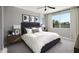 Serene bedroom with a large bed, stylish decor, and a window providing scenic views of the surrounding landscape at 1007 Wisteria Way, Dundee, FL 33838