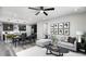 Open-concept living space showcasing stylish furniture, modern decor, and an open flow to the kitchen and dining area at 1007 Wisteria Way, Dundee, FL 33838