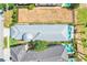 Aerial shot of a house with a fenced in backyard and a large silver roof at 1021 Castle Pines Ct, Reunion, FL 34747
