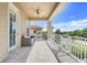 Balcony with tile floor and ceiling fan overlooking a green area with view of a neighboring building at 1021 Castle Pines Ct, Reunion, FL 34747