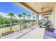 Wide balcony with ceiling fan and chaise lounge overlooking golf course, palm trees and other residences at 1021 Castle Pines Ct, Reunion, FL 34747