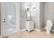 Bright bathroom with single vanity, tile flooring, and access to the backyard, offering convenience at 1021 Castle Pines Ct, Reunion, FL 34747