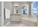 Bright bathroom featuring a soaking tub, vanity, and elegant decor for a spa-like retreat at 1021 Castle Pines Ct, Reunion, FL 34747