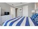 Well-lit bedroom with crown molding featuring a TV, dresser and open doorway at 1021 Castle Pines Ct, Reunion, FL 34747