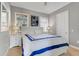 Comfortable bedroom with large window, white furniture and calm blue accents at 1021 Castle Pines Ct, Reunion, FL 34747