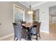 Breakfast nook with a wood table, stylish chairs, and bright natural light at 1021 Castle Pines Ct, Reunion, FL 34747