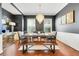 Elegant dining room with hardwood floors, modern light fixture, and ample seating at 1021 Castle Pines Ct, Reunion, FL 34747