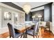 Elegant dining room featuring hardwood floors, a dazzling chandelier, and stylish decor at 1021 Castle Pines Ct, Reunion, FL 34747