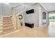 Bright foyer with staircase, tan tile flooring, a coat rack, and stylish decorative elements at 1021 Castle Pines Ct, Reunion, FL 34747