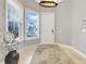 Bright foyer with a white front door, tile flooring, and a decorative rug at 1021 Castle Pines Ct, Reunion, FL 34747