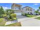 Lovely two-story house with a stone facade, a second-story balcony, and a paved driveway at 1021 Castle Pines Ct, Reunion, FL 34747