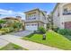 Beautiful two-story home with a stone facade, a balcony, a paved driveway, and well-maintained lawn at 1021 Castle Pines Ct, Reunion, FL 34747