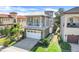 Charming two-story home with stone accents, a balcony, a paved driveway, and lush landscaping at 1021 Castle Pines Ct, Reunion, FL 34747