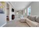 Upstairs hallway with carpet and chandelier, next to a living room with a couch and pillows at 1021 Castle Pines Ct, Reunion, FL 34747