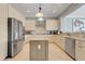 Bright kitchen with an island, stainless steel appliances, and granite countertops at 1021 Castle Pines Ct, Reunion, FL 34747