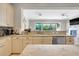 Open kitchen boasts granite countertops, stainless steel appliances, and a view of the backyard at 1021 Castle Pines Ct, Reunion, FL 34747