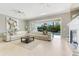 Open living room with modern decor and views of the outdoor pool area at 1021 Castle Pines Ct, Reunion, FL 34747