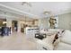 Spacious living room open to kitchen with tile floors, neutral tones, and abundant natural light at 1021 Castle Pines Ct, Reunion, FL 34747