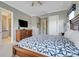 Bedroom features a king bed, dresser, carpet, with doorway to bathroom and another exit door at 1021 Castle Pines Ct, Reunion, FL 34747