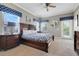 Bedroom with a king-sized bed, and bedside tables, with light from windows and glass patio door at 1021 Castle Pines Ct, Reunion, FL 34747
