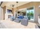 Outdoor patio features a stone fireplace, tv, ceiling fan, with a view to indoor fireplace and pool at 1021 Castle Pines Ct, Reunion, FL 34747