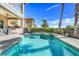 Backyard pool with a built-in spa and outdoor seating area at 1021 Castle Pines Ct, Reunion, FL 34747