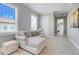 Comfortable sitting area with plush seating, neutral tones, and natural light from large windows at 1021 Castle Pines Ct, Reunion, FL 34747