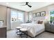 Bright bedroom showcases a large window, plush carpet, and elegant furniture at 1034 Wisteria Way, Dundee, FL 33838