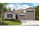 Charming single-Gathering home featuring a neutral color scheme and attached two car garage at 1034 Wisteria Way, Dundee, FL 33838