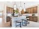 Modern kitchen with stylish pendant lighting, ample counter space, and stainless steel appliances at 1034 Wisteria Way, Dundee, FL 33838