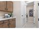 Functional laundry room with built-in cabinets, countertop space, and modern appliances at 1034 Wisteria Way, Dundee, FL 33838