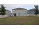 Large back yard with partial fence and view of neighboring homes at 11273 Amber Ridge Dr, Zellwood, FL 32798