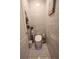 Modern bathroom featuring a toilet with blue lighting and a tiled wall, blending style and functionality at 11273 Amber Ridge Dr, Zellwood, FL 32798