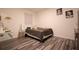 Bedroom featuring a minimalist bed frame, modern flooring, and neutral wall art at 11273 Amber Ridge Dr, Zellwood, FL 32798