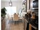 Stylish dining area with modern white chairs, a black vase, and a sleek lighting fixture at 11273 Amber Ridge Dr, Zellwood, FL 32798