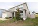 Charming two-story home featuring a side entry garage and manicured landscaping at 11273 Amber Ridge Dr, Zellwood, FL 32798