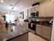 Well-equipped kitchen with a center island, stainless steel appliances, and an adjacent dining area at 11273 Amber Ridge Dr, Zellwood, FL 32798