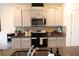 Well-organized kitchen with modern appliances, stylish backsplash, and ample counter space at 11273 Amber Ridge Dr, Zellwood, FL 32798
