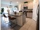 Open-concept kitchen featuring a granite island with seating, and stainless steel appliances at 11273 Amber Ridge Dr, Zellwood, FL 32798