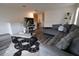 Inviting living area with comfortable gray sofas, modern rug, and a fireplace under the TV at 11273 Amber Ridge Dr, Zellwood, FL 32798