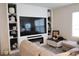 Cozy living room with custom built-in shelving, a large television, and comfortable seating at 11273 Amber Ridge Dr, Zellwood, FL 32798
