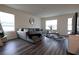 Bright living room with gray sofa, contemporary rug, and ample natural light from large windows at 11273 Amber Ridge Dr, Zellwood, FL 32798