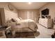 Comfortable bedroom featuring a large bed with soft bedding, a dresser, and neutral decor for a relaxing ambiance at 11273 Amber Ridge Dr, Zellwood, FL 32798