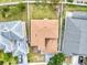 An aerial view shows the tan roof, backyard, and surrounding neighborhood at 1176 Epson Oaks Way, Orlando, FL 32837