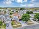 Aerial view of a residential neighborhood showcasing a two-story home with a well-manicured lawn and a large driveway at 1176 Epson Oaks Way, Orlando, FL 32837