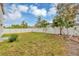 Expansive backyard with a white fence and mature landscaping, providing a private outdoor retreat at 1176 Epson Oaks Way, Orlando, FL 32837